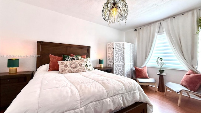 8449 NW 4th Ave Unit 8449, Miami, FL 33150 - bedroom featuring a chandelier and wood finished floors