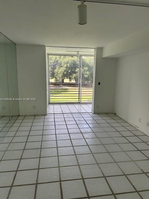 3503 Oaks Way Unit 212, Pompano Beach, FL 33069 - empty room featuring light tile patterned floors