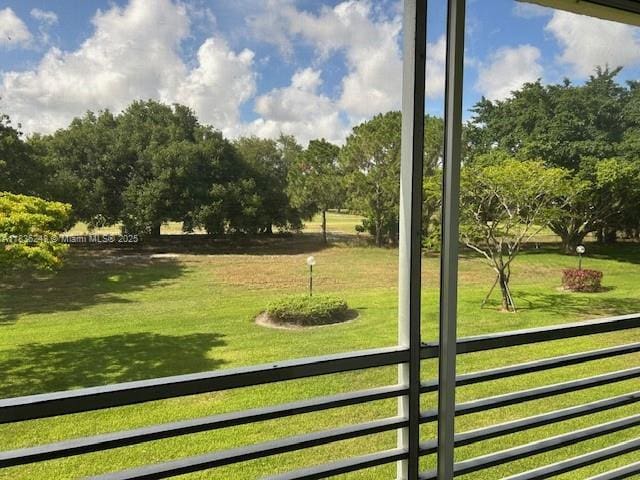3503 Oaks Way Unit 212, Pompano Beach, FL 33069 - doorway to outside featuring view of wooded area