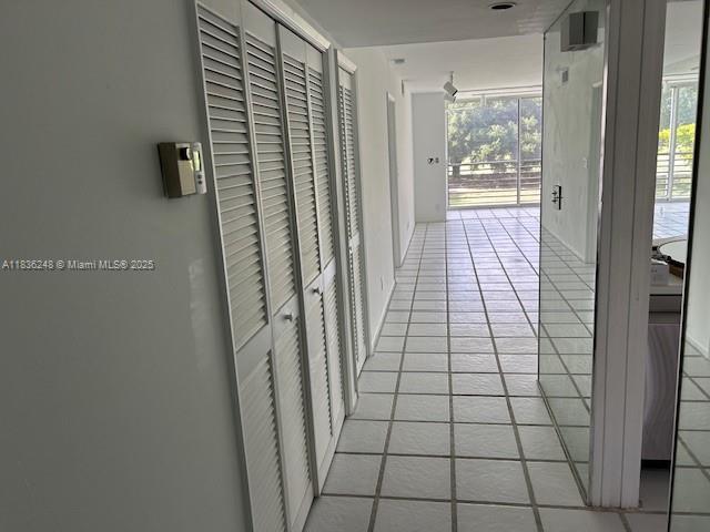 3503 Oaks Way Unit 212, Pompano Beach, FL 33069 - hallway with light tile patterned floors