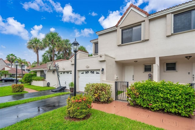 21160 Mainsail Cir Unit H12, Aventura, FL 33180 - view of front of house with stucco siding, asphalt driveway, a tiled roof, and an attached garage