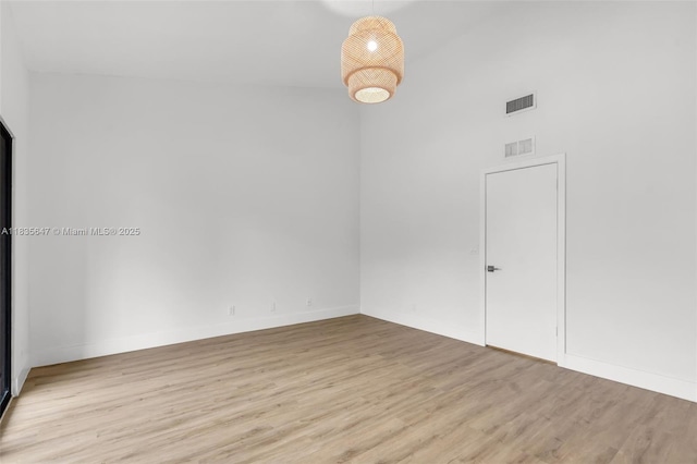 21160 Mainsail Cir Unit H12, Aventura, FL 33180 - empty room featuring wood finished floors and a high ceiling