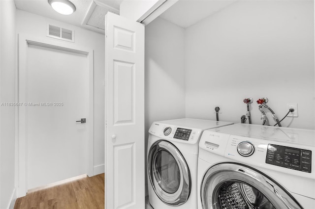 21160 Mainsail Cir Unit H12, Aventura, FL 33180 - laundry area featuring washing machine and dryer and light wood finished floors