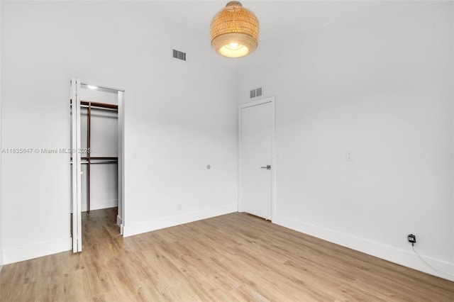 21160 Mainsail Cir Unit H12, Aventura, FL 33180 - unfurnished bedroom featuring light wood-type flooring, a closet, and a walk in closet