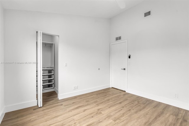 21160 Mainsail Cir Unit H12, Aventura, FL 33180 - unfurnished bedroom with a closet, light wood-style flooring, and a walk in closet