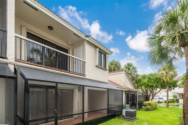 21160 Mainsail Cir Unit H12, Aventura, FL 33180 - rear view of house featuring a tiled roof, stucco siding, a lawn, and a balcony