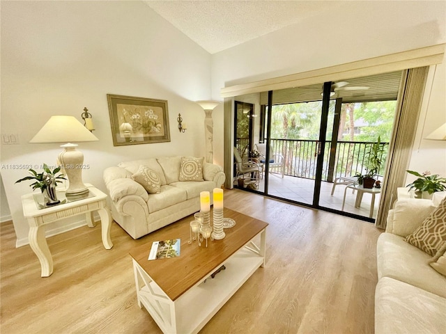 3137 S Carambola Cir S Unit 2369, Coconut Creek, FL 33066 - living room featuring lofted ceiling, light wood finished floors, and a textured ceiling