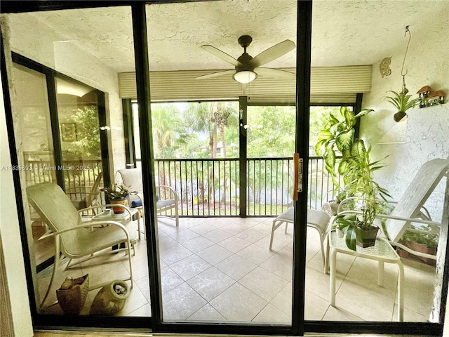 3137 S Carambola Cir S Unit 2369, Coconut Creek, FL 33066 - sunroom / solarium featuring a ceiling fan, tile patterned flooring, a textured ceiling, and a textured wall