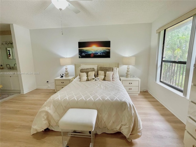 3137 S Carambola Cir S Unit 2369, Coconut Creek, FL 33066 - bedroom with light wood-type flooring, a textured ceiling, and a ceiling fan