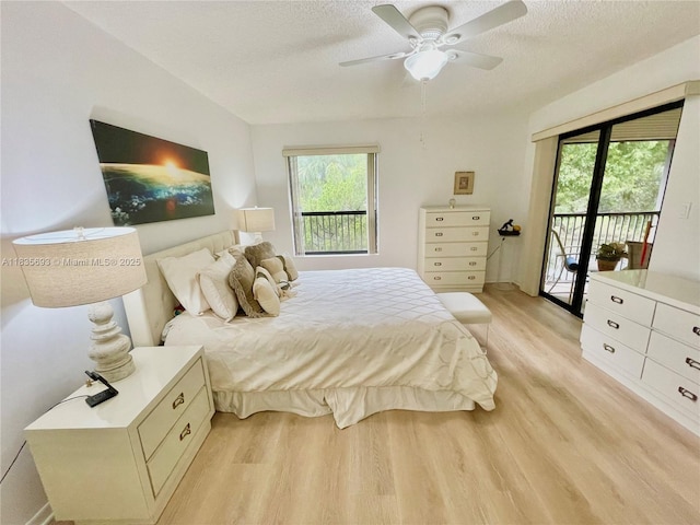 3137 S Carambola Cir S Unit 2369, Coconut Creek, FL 33066 - bedroom featuring light wood finished floors, access to outside, a textured ceiling, and a ceiling fan