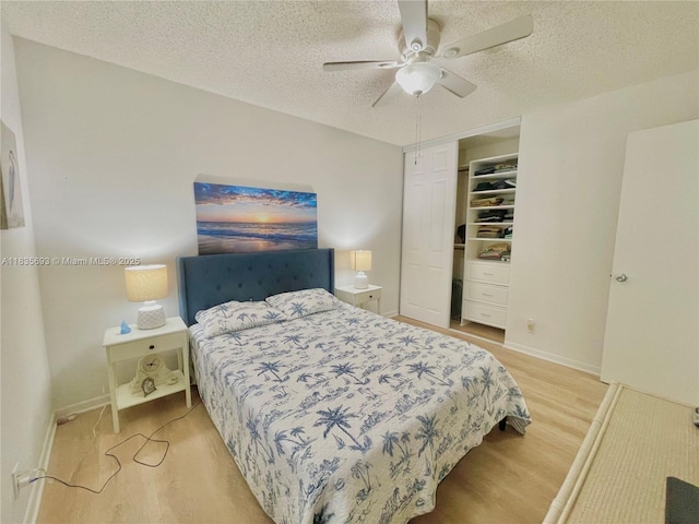 3137 S Carambola Cir S Unit 2369, Coconut Creek, FL 33066 - bedroom featuring light wood-type flooring, a textured ceiling, ceiling fan, and a closet