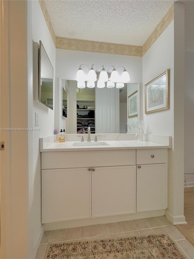 3137 S Carambola Cir S Unit 2369, Coconut Creek, FL 33066 - full bathroom with tile patterned flooring, a textured ceiling, vanity, and a walk in closet