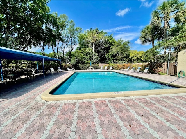 3137 S Carambola Cir S Unit 2369, Coconut Creek, FL 33066 - community pool with a patio area and view of scattered trees