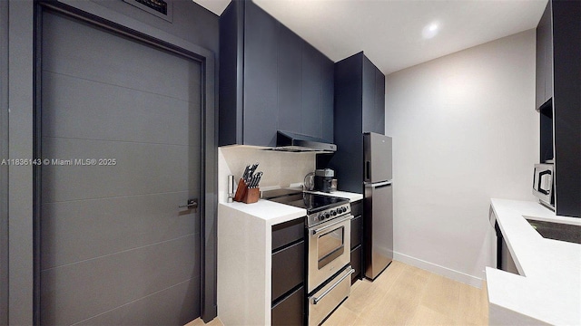 10824 N Kendall Dr Unit S28, Miami, FL 33176 - kitchen featuring appliances with stainless steel finishes, range hood, light wood-style floors, light countertops, and modern cabinets