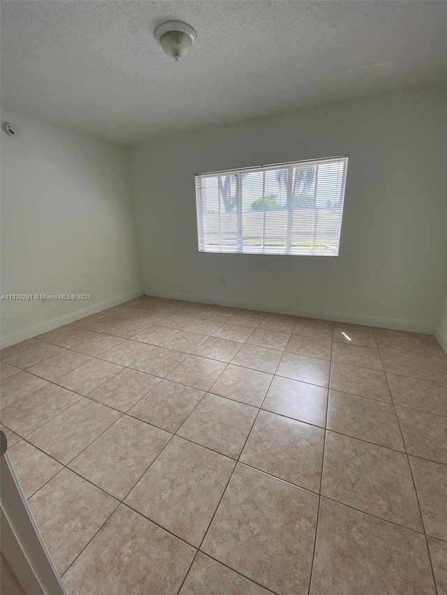 2452 Centergate Dr Unit 103, Miramar, FL 33025 - empty room with a textured ceiling and light tile patterned floors