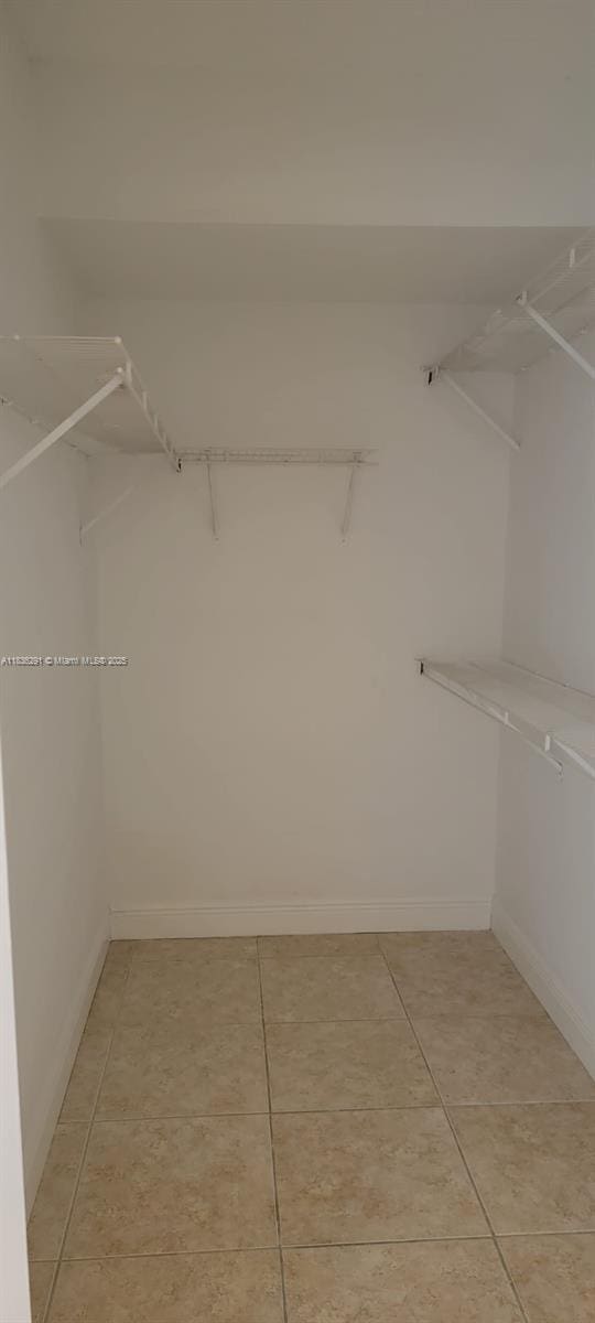 2452 Centergate Dr Unit 103, Miramar, FL 33025 - walk in closet with light tile patterned flooring