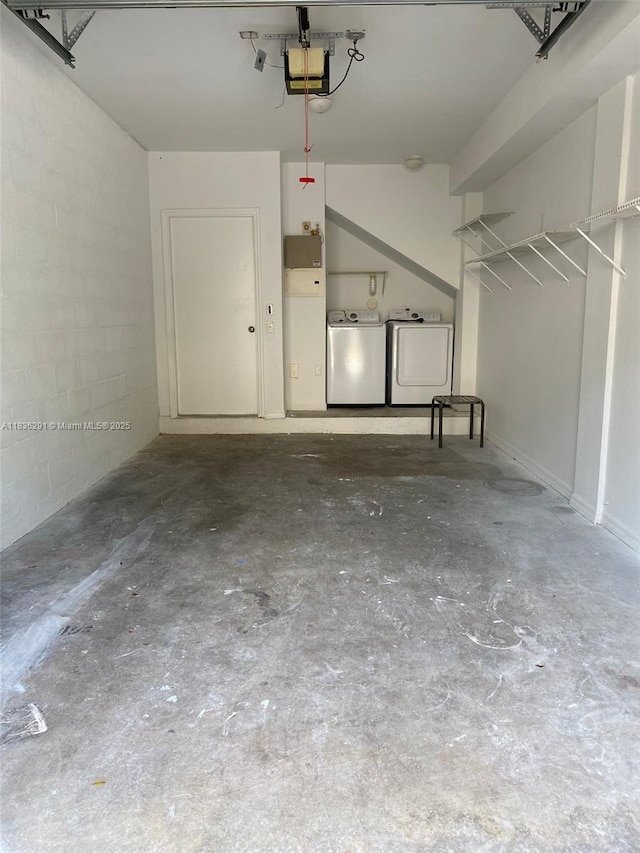 2452 Centergate Dr Unit 103, Miramar, FL 33025 - garage featuring washing machine and clothes dryer, a garage door opener, and concrete block wall