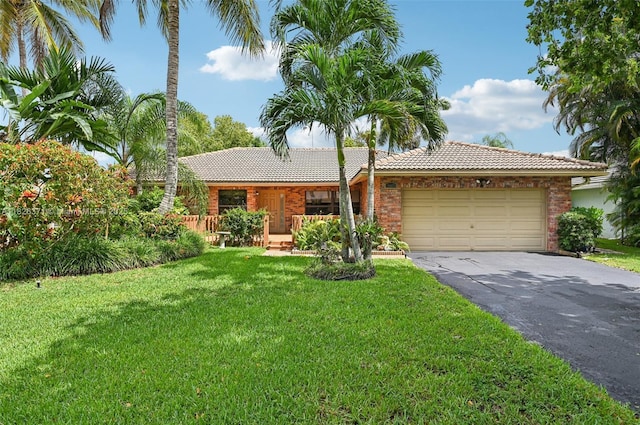 10875 NW 17th Mnr, Coral Springs, FL 33071 - ranch-style home with a tiled roof, asphalt driveway, a front yard, a garage, and brick siding