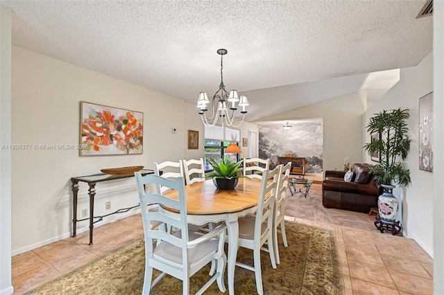 10875 NW 17th Mnr, Coral Springs, FL 33071 - dining room featuring light tile patterned floors, a chandelier, vaulted ceiling, and a textured ceiling