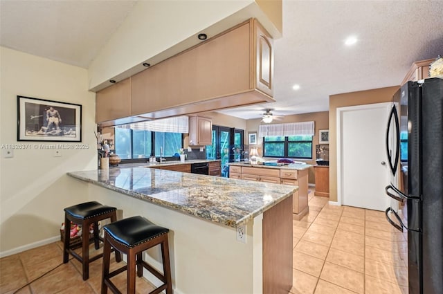 10875 NW 17th Mnr, Coral Springs, FL 33071 - kitchen featuring black appliances, a peninsula, light tile patterned floors, recessed lighting, and light stone counters