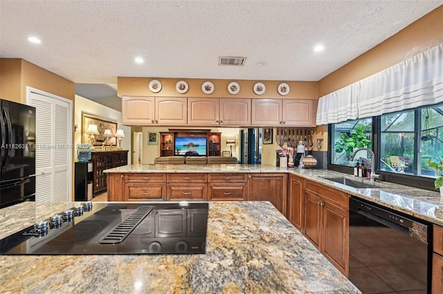 10875 NW 17th Mnr, Coral Springs, FL 33071 - kitchen with black appliances, light stone counters, a textured ceiling, and recessed lighting