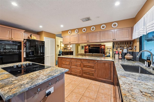 10875 NW 17th Mnr, Coral Springs, FL 33071 - kitchen featuring black appliances, light stone countertops, recessed lighting, light tile patterned floors, and a textured ceiling