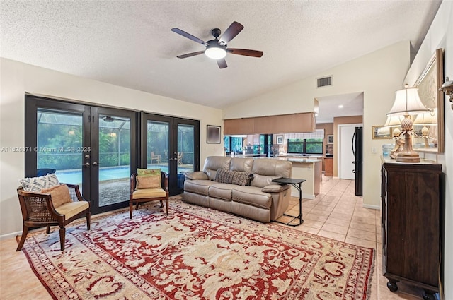 10875 NW 17th Mnr, Coral Springs, FL 33071 - living room featuring french doors, lofted ceiling, ceiling fan, a textured ceiling, and light tile patterned floors
