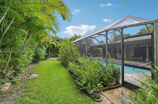 10875 NW 17th Mnr, Coral Springs, FL 33071 - swimming pool with a lawn, a patio area, a ceiling fan, and glass enclosure