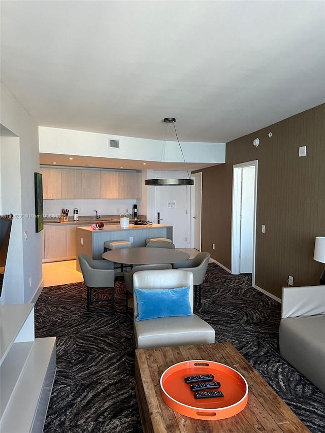 4111 S Ocean Dr Unit 2004, Hollywood, FL 33019 - kitchen with a center island, modern cabinets, light countertops, light brown cabinetry, and carpet flooring