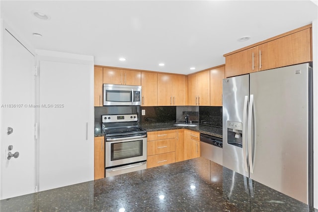 2333 Brickell Ave Unit 1908, Miami, FL 33129 - kitchen with appliances with stainless steel finishes, dark stone counters, and recessed lighting