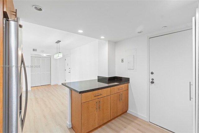 2333 Brickell Ave Unit 1908, Miami, FL 33129 - kitchen featuring freestanding refrigerator, light wood-style floors, a peninsula, electric panel, and decorative light fixtures