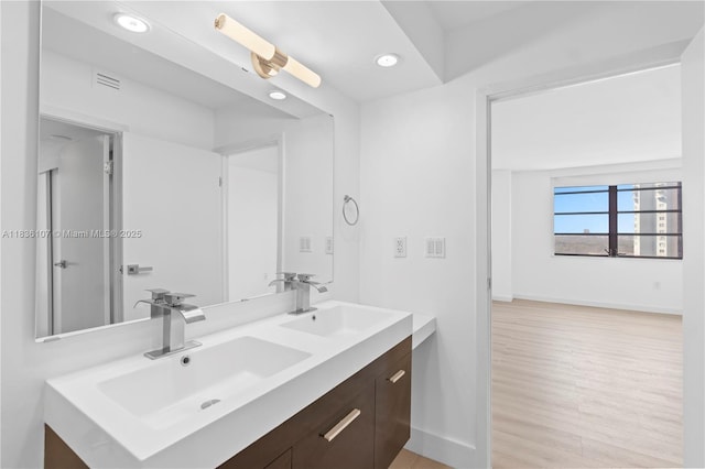 2333 Brickell Ave Unit 1908, Miami, FL 33129 - bathroom with double vanity, wood finished floors, and recessed lighting