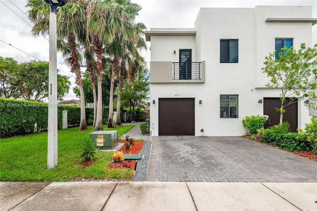 401 SW 91st Ave, Miami, FL 33174 - view of front of home featuring decorative driveway, an attached garage, stucco siding, a front yard, and a balcony