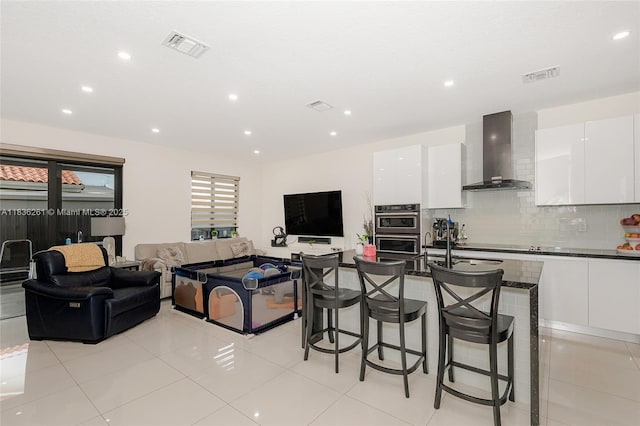 401 SW 91st Ave, Miami, FL 33174 - kitchen with wall chimney range hood, modern cabinets, a kitchen breakfast bar, white cabinets, and decorative backsplash