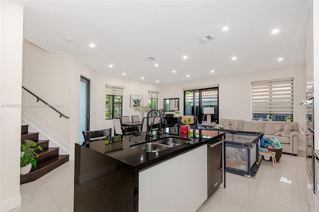 401 SW 91st Ave, Miami, FL 33174 - kitchen with a kitchen island with sink, dark stone countertops, light tile patterned floors, open floor plan, and stainless steel oven