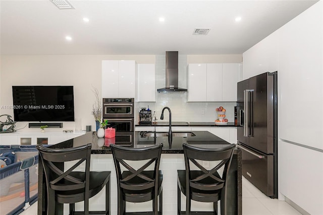 401 SW 91st Ave, Miami, FL 33174 - kitchen featuring wall chimney range hood, high end fridge, stainless steel double oven, white cabinetry, and dark countertops