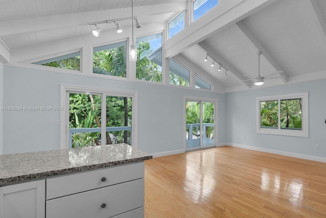 81975 Old Hwy, Islamorada, FL 33036 - unfurnished living room with track lighting, light wood-style floors, high vaulted ceiling, a ceiling fan, and a wooden ceiling with exposed beams
