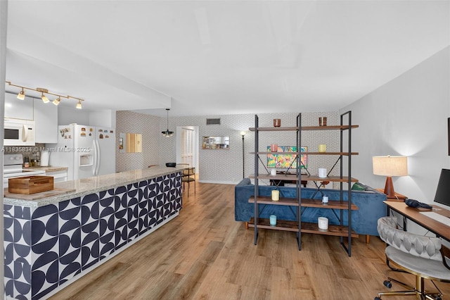 1340 Lincoln Rd Unit 403, Miami Beach, FL 33139 - living area with wallpapered walls and light wood-type flooring