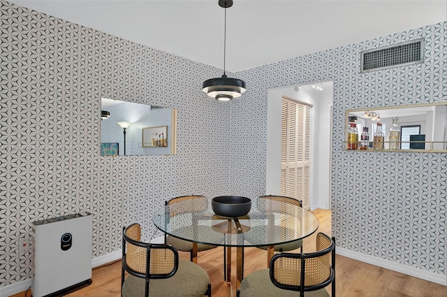 1340 Lincoln Rd Unit 403, Miami Beach, FL 33139 - dining area with wood finished floors and wallpapered walls