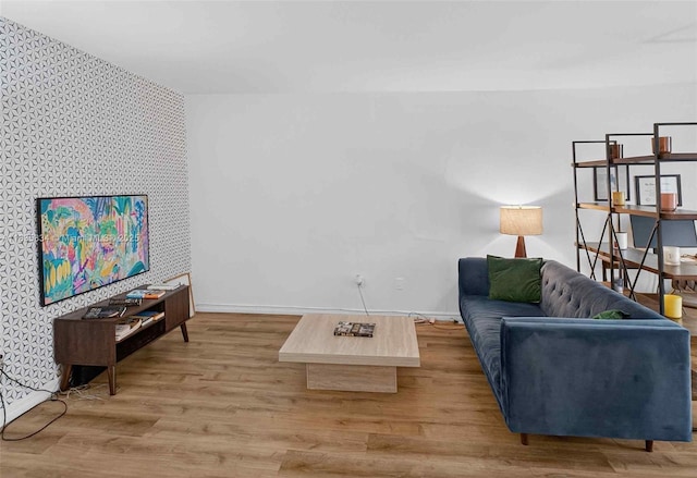 1340 Lincoln Rd Unit 403, Miami Beach, FL 33139 - living room featuring an accent wall, wallpapered walls, and wood finished floors