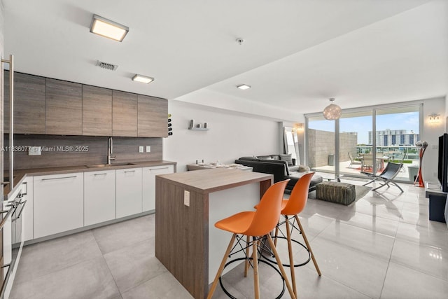 400 Sunny Isles Blvd Unit 616, Sunny Isles Beach, FL 33160 - kitchen with open floor plan, modern cabinets, a kitchen breakfast bar, a center island, and a wall of windows