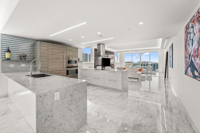 400 Sunny Isles Blvd Unit 2008, Sunny Isles Beach, FL 33160 - kitchen with modern cabinets, wall chimney exhaust hood, light marble finish flooring, light stone counters, and recessed lighting