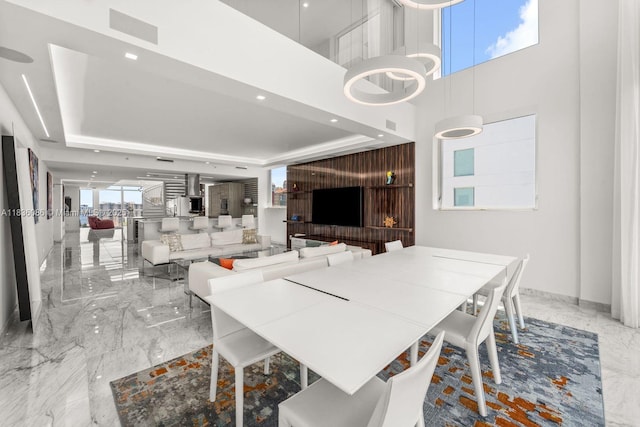 400 Sunny Isles Blvd Unit 2008, Sunny Isles Beach, FL 33160 - dining room featuring marble tiled flooring, a raised ceiling, recessed lighting, and a towering ceiling