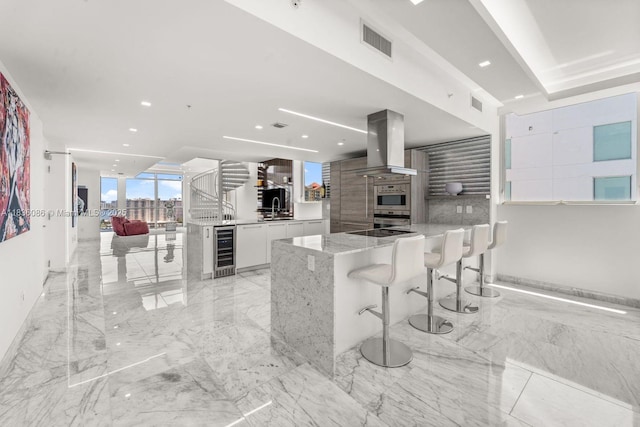 400 Sunny Isles Blvd Unit 2008, Sunny Isles Beach, FL 33160 - kitchen with island range hood, wine cooler, a peninsula, white cabinetry, and modern cabinets