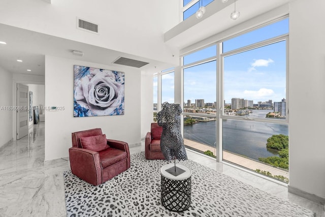 400 Sunny Isles Blvd Unit 2008, Sunny Isles Beach, FL 33160 - living area featuring marble tiled floors, a water view, a city view, and recessed lighting