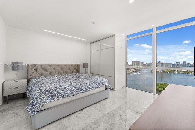 400 Sunny Isles Blvd Unit 2008, Sunny Isles Beach, FL 33160 - bedroom featuring expansive windows, a water view, a view of city, a closet, and marble finish flooring