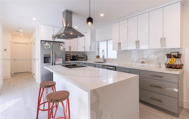 380 Morningside Dr, Miami Springs, FL 33166 - kitchen featuring island exhaust hood, stainless steel appliances, a center island, modern cabinets, and a kitchen breakfast bar