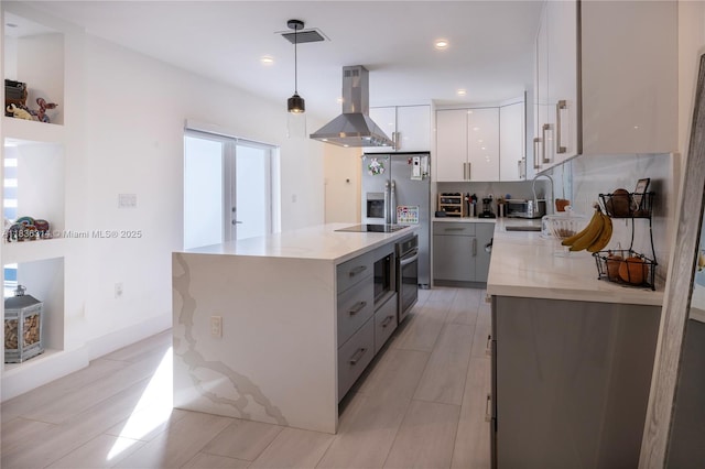 380 Morningside Dr, Miami Springs, FL 33166 - kitchen with ventilation hood, stainless steel appliances, modern cabinets, white cabinets, and pendant lighting