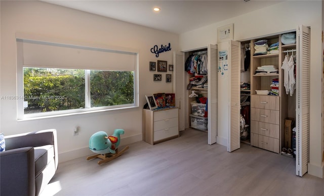 380 Morningside Dr, Miami Springs, FL 33166 - bedroom with two closets, light wood-style floors, and recessed lighting