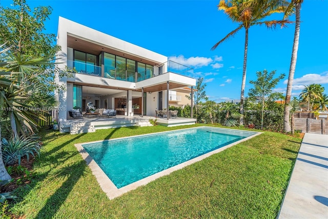 1510 Stillwater Dr, Miami Beach, FL 33141 - back of property with a balcony, stucco siding, a patio area, and an outdoor pool